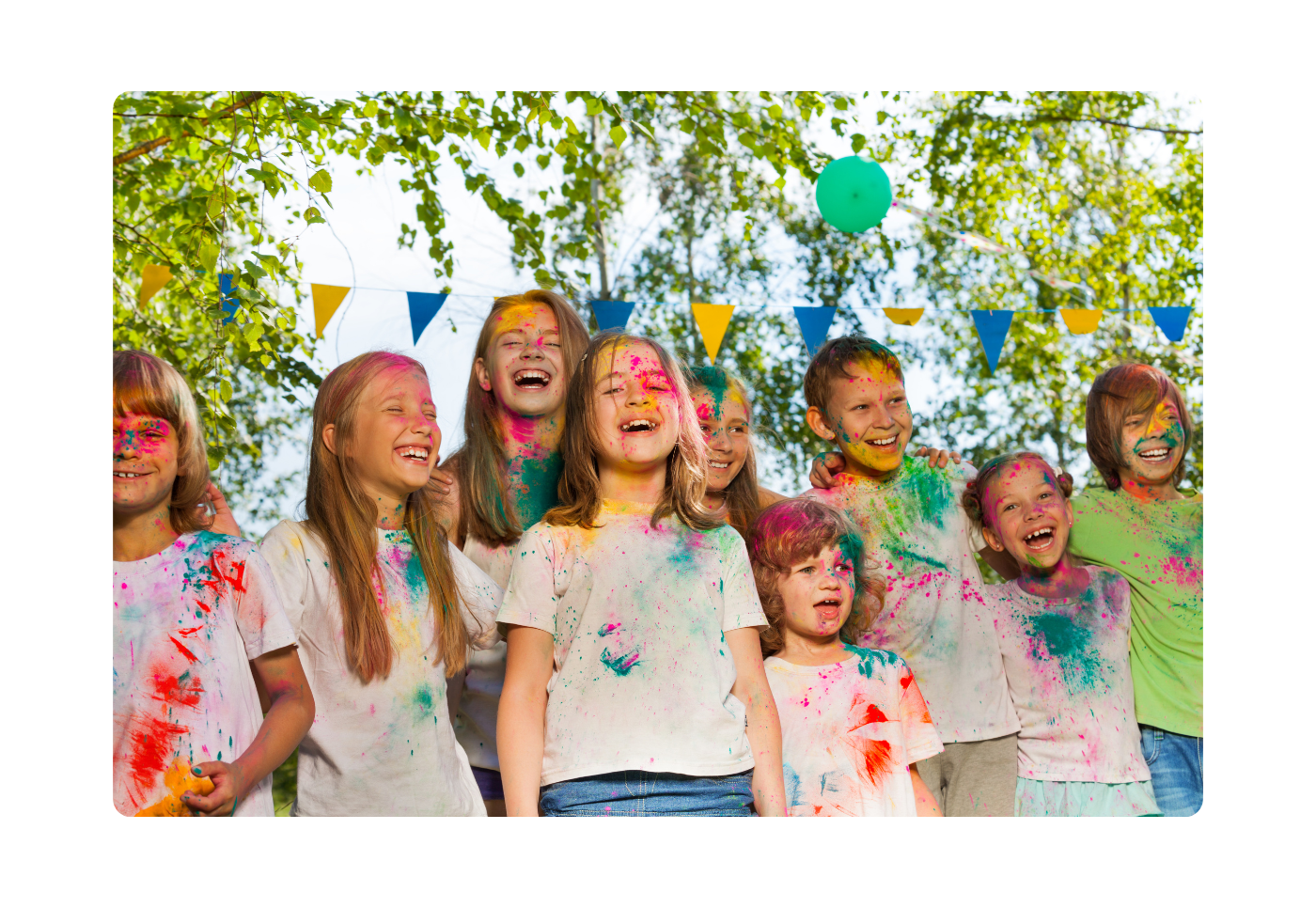 Group of laughing kids having fun playing with colours